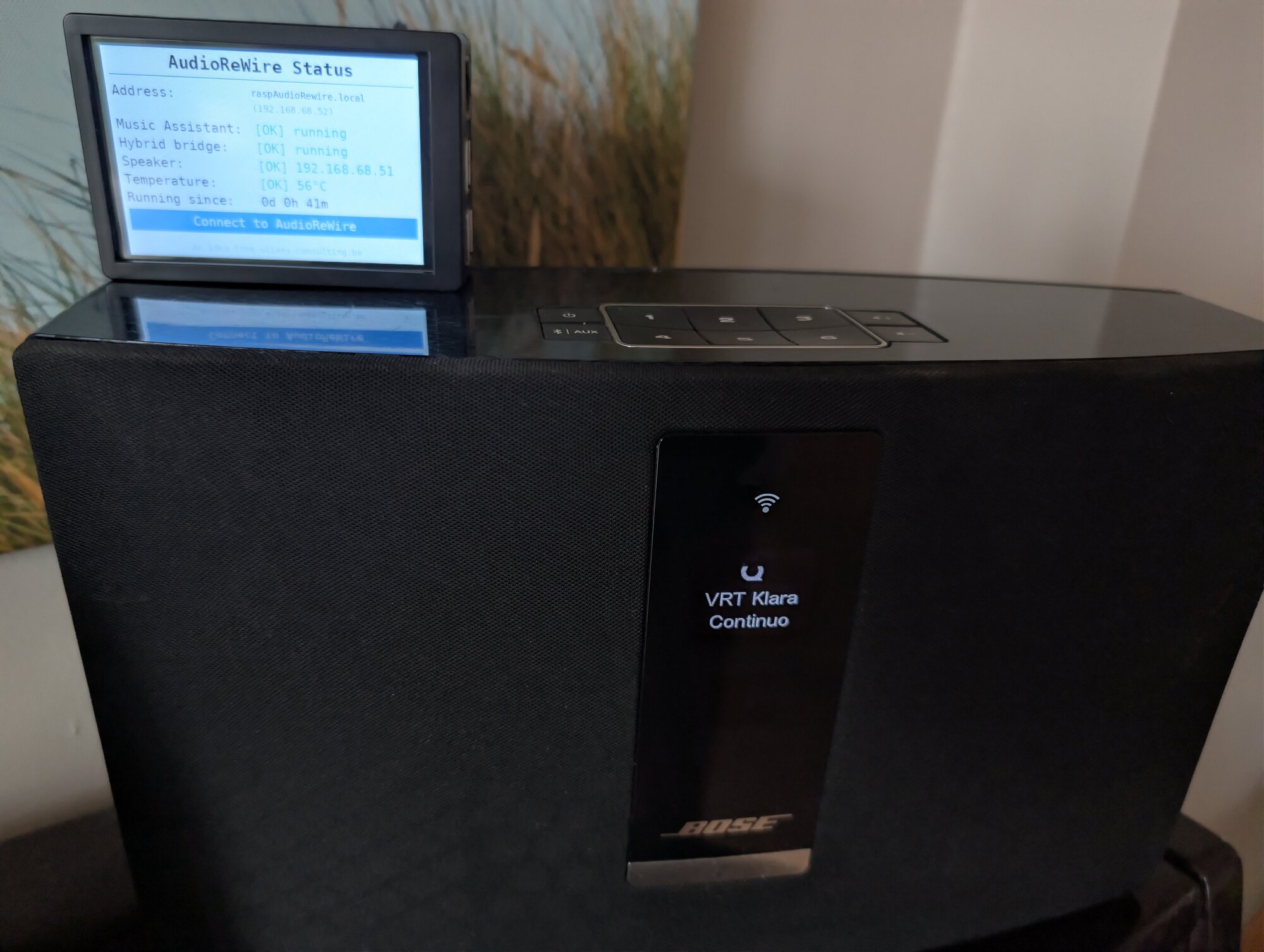 audiorewire clipped on top of a Bose SoundTouch speaker in a living room
